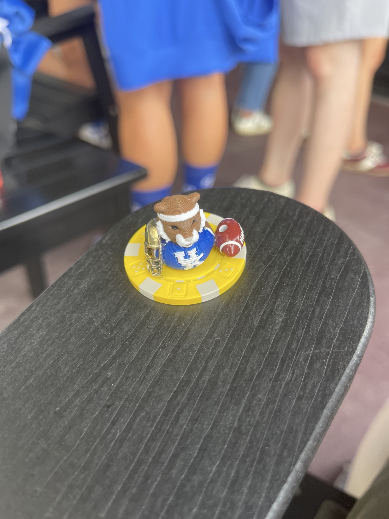 Kentucky Wildcats poker chip duck with a tiny football and helmet, perched on a yellow poker chip